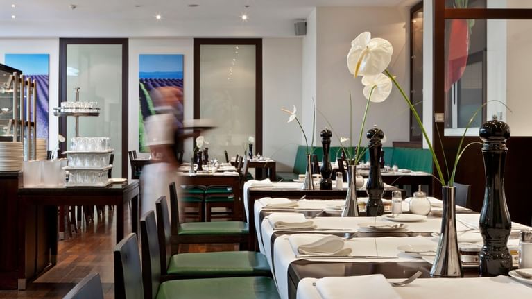 Well-arranged dining table setup in a stylish restaurant at Flemings Hotel Wien-Stadthalle