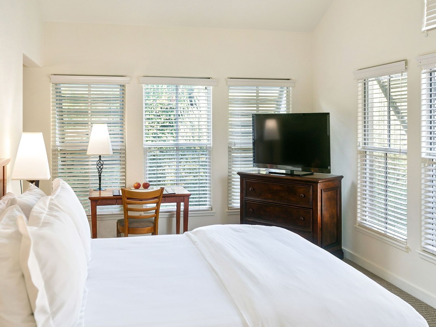 Southbridge Suite bedroom with bed, desk and TV