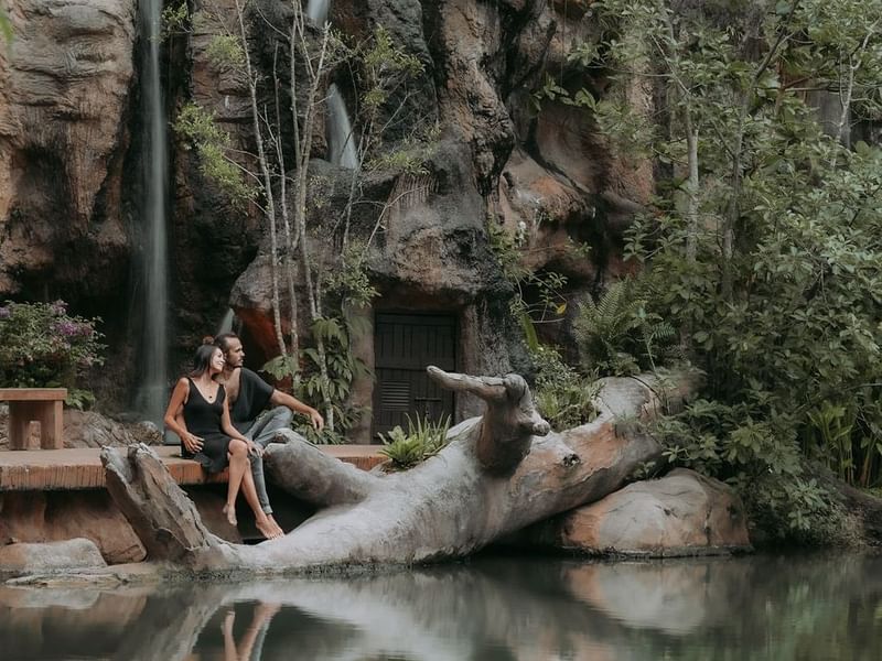 Couple gazing at the lake from the deck promoting celebrate love package at The Banjaran Hotsprings Retreat