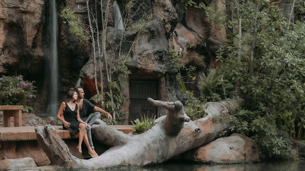 Couple gazing at the lake from the deck promoting celebrate love package at The Banjaran Hotsprings Retreat