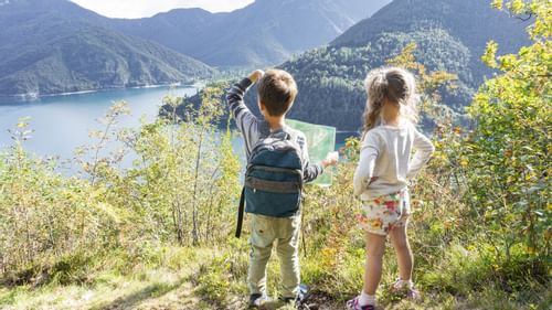 Children looking out at lake and mountains