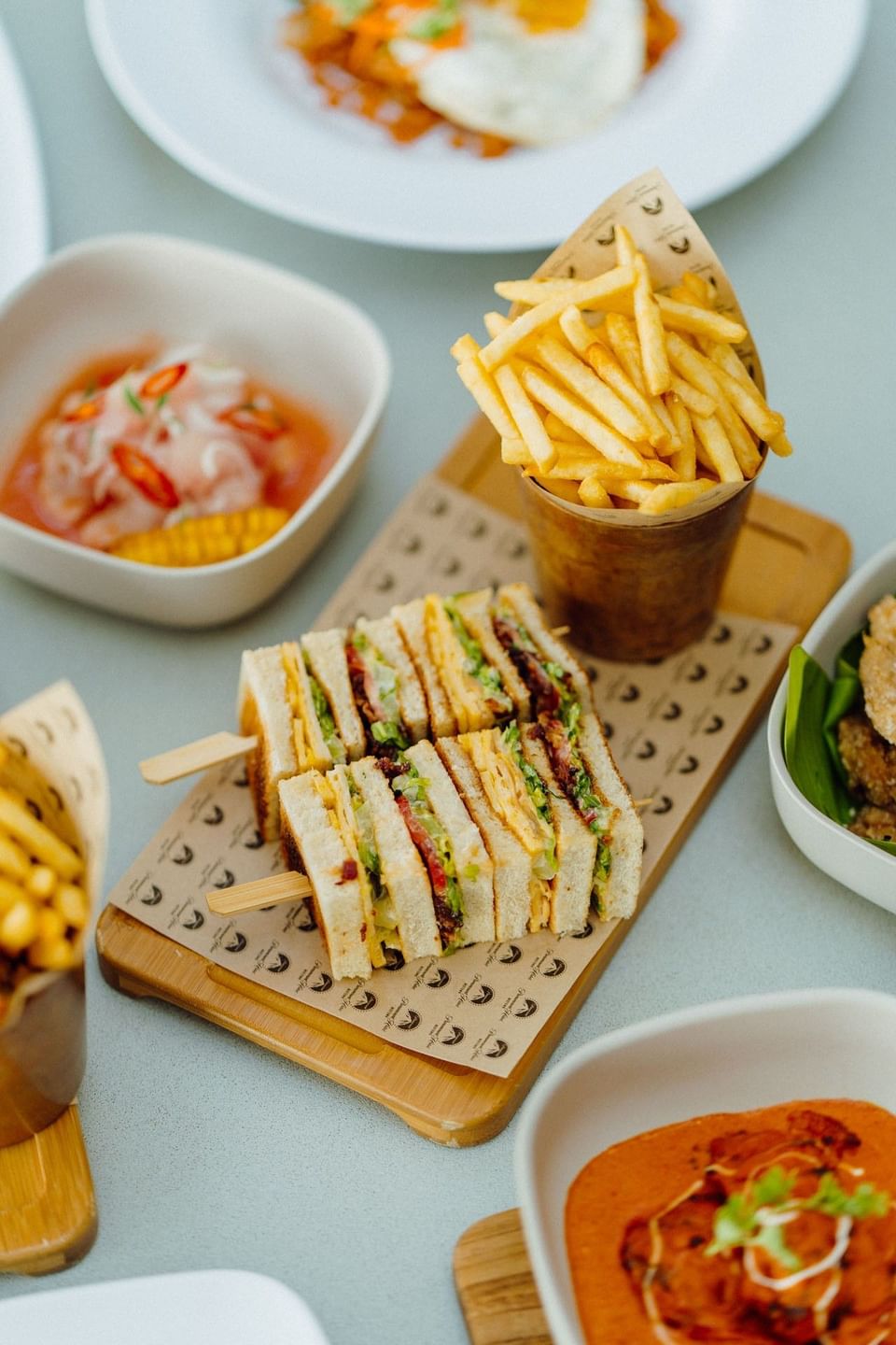 Club sandwiches on skewers with French fries and side dishes at Malibu Sky Lounge & Bar, one of the best lounges in Dubai