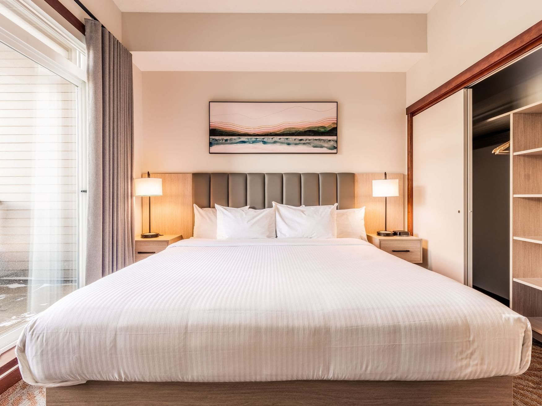 Comfy bed with head board and nightstands in One Bedroom Suite at Blackstone Mountain Lodge