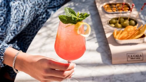 A person holding a cocktail in Azimuth Rooftop Bar near Almanac Barcelona