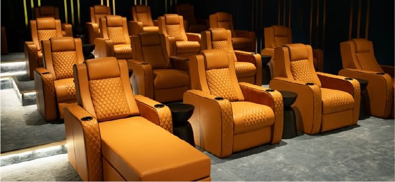 Luxurious leather recliner seats arranged in a stylish Movie Lounge room under modern lighting at DAMAC Maison Aykon City