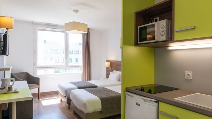 Twin room with a kitchenette at The Originals Hotels