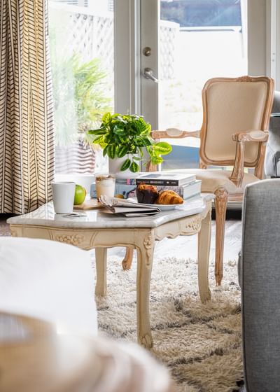 Elegant marble coffee table with breakfast and books in a bright, stylishly curated room at Riviera Hotel South Beach