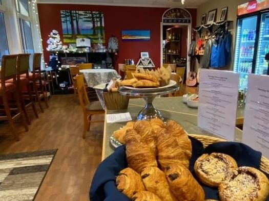 Fresh croissant baskets and dining tables in Moorings Market at Poets Cove Resort & Spa