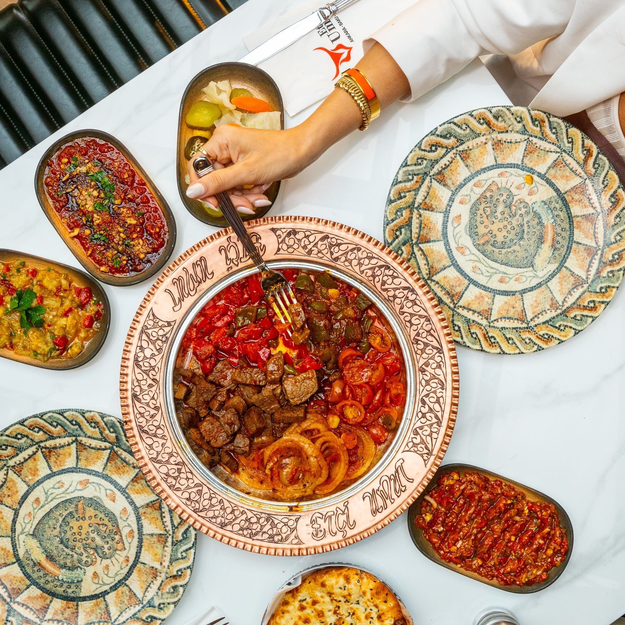 Table setting with Turkish grilled meat, vegetables, and bread served in Restaurant and Lounge at DAMAC Maison Aykon City