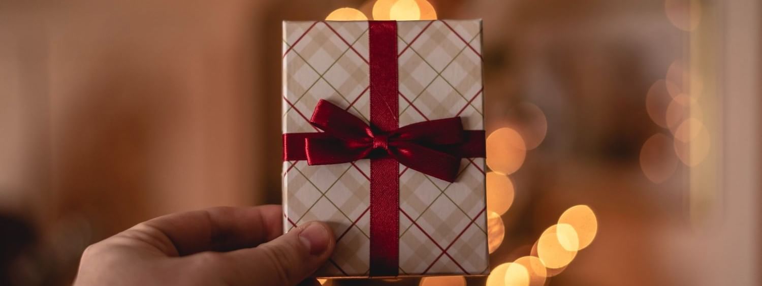 Close-up of a person hand holding small wrapped gift card at Pullman Port Douglas