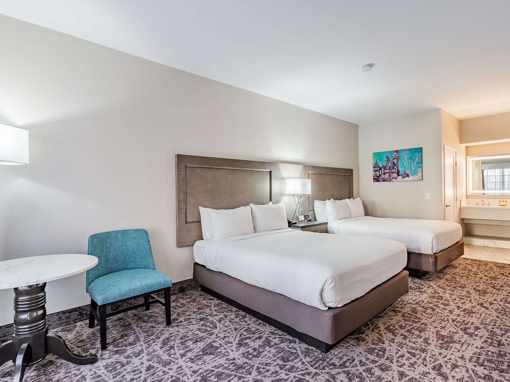 Luxury Plus room with two queen beds and modern furniture 
