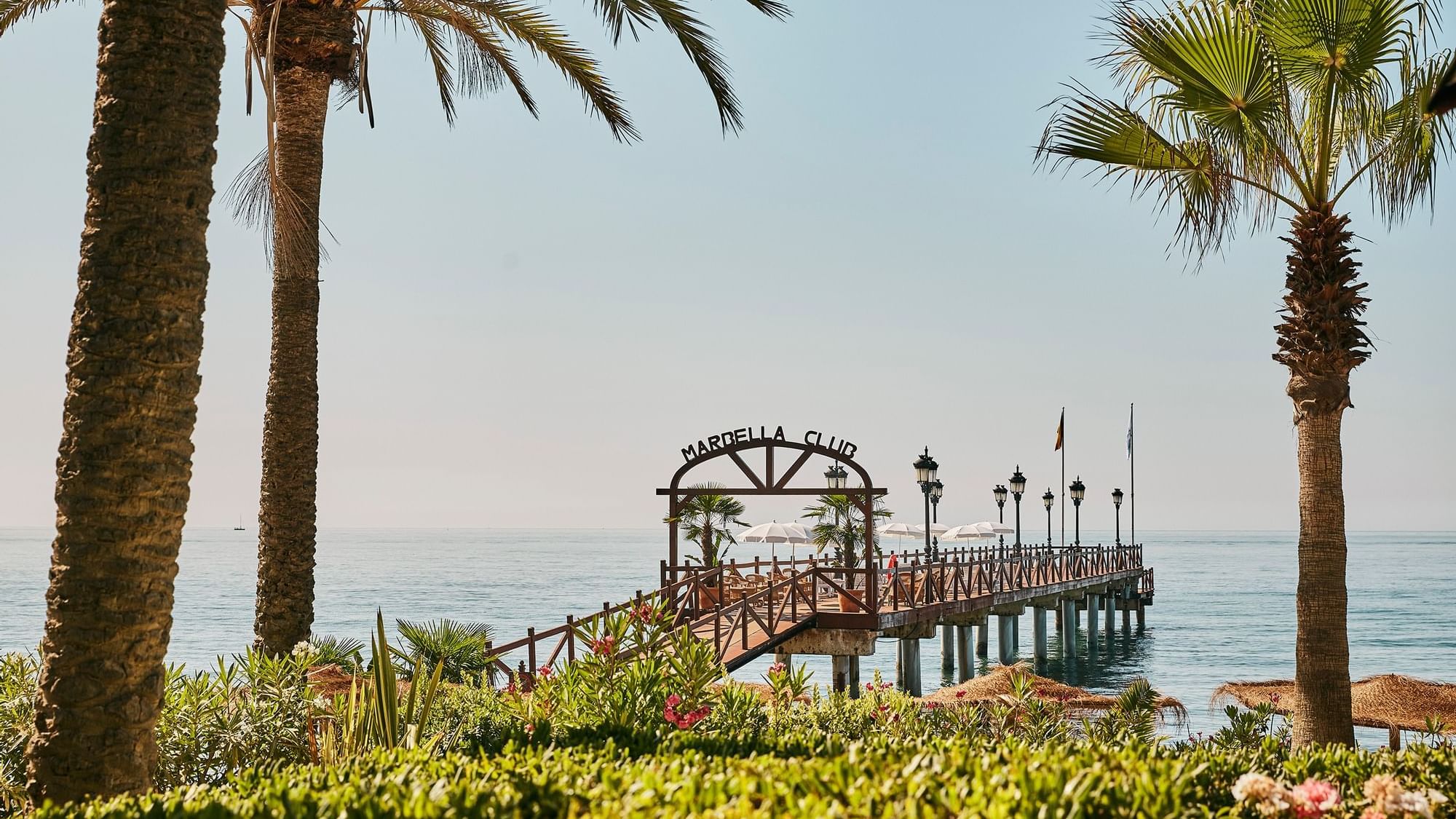 A pier with street lights by the Beach at Marbella Club Hotel