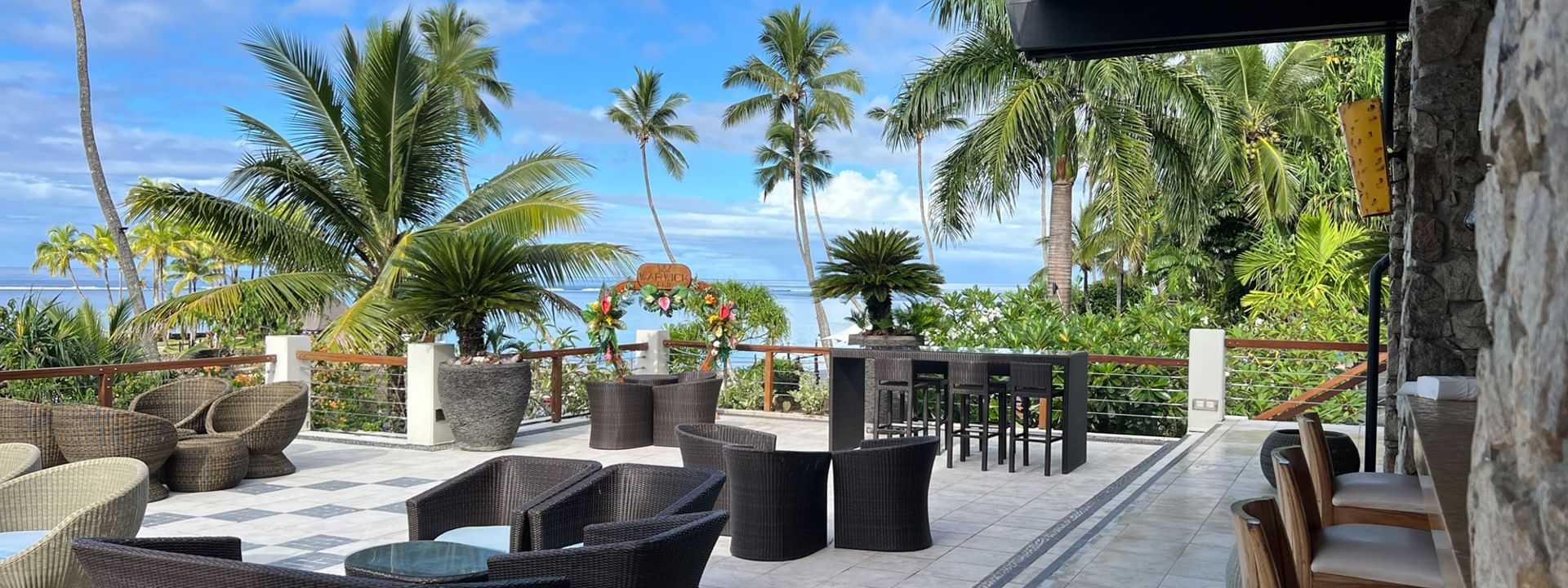Outdoor seating area with ocean view at Sunset Terrace Bar, Warwick Fiji Resort and Spa, Korolevu