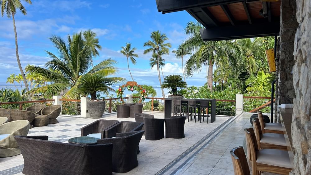 Outdoor seating area with ocean view at Sunset Terrace Bar, Warwick Fiji Resort and Spa, Korolevu.