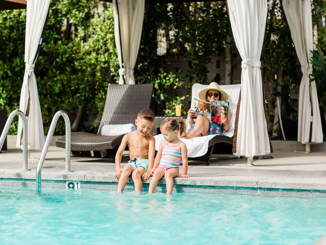 View Of Two Kids Playing Near The Pool At Luxe Sunset Boulevard
