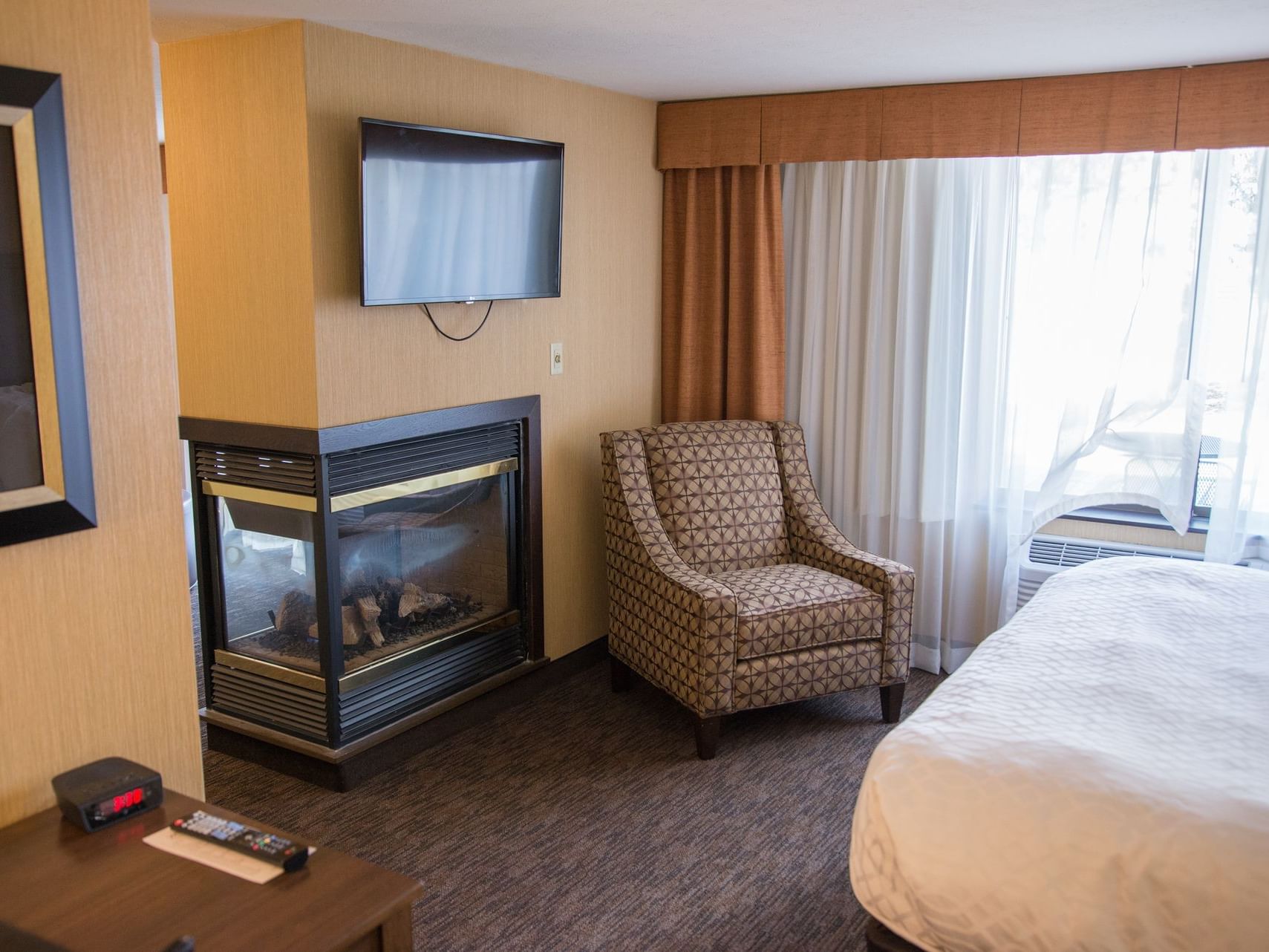 Deluxe Suite with a fireplace & television at Evergreen Resort