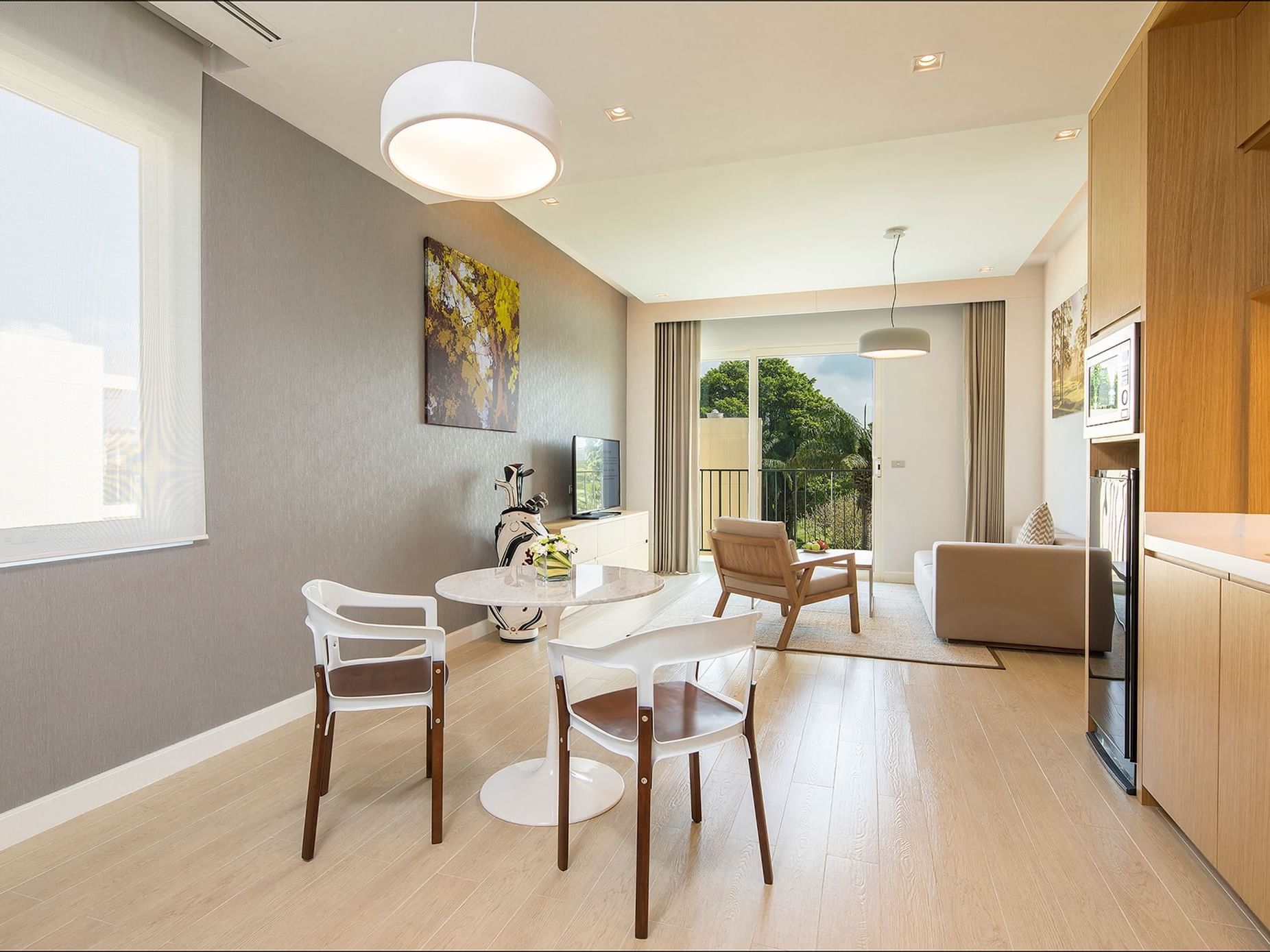 Dining & lounge area with wooden floors in One-Bedroom Suite at Eastin Thana City Golf Resort Bangkok