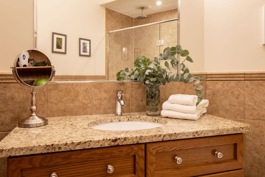 Bathroom vanity with mirror & towels in King Superior Home Suite Home at Retro Suites Hotel