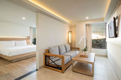 Living area with window view in Junior Suite at Eastin Ashta Resort Canggu