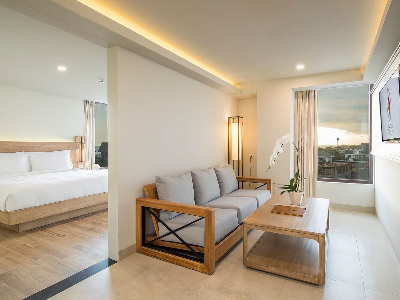 Living area with window view in Junior Suite at Eastin Ashta Resort Canggu