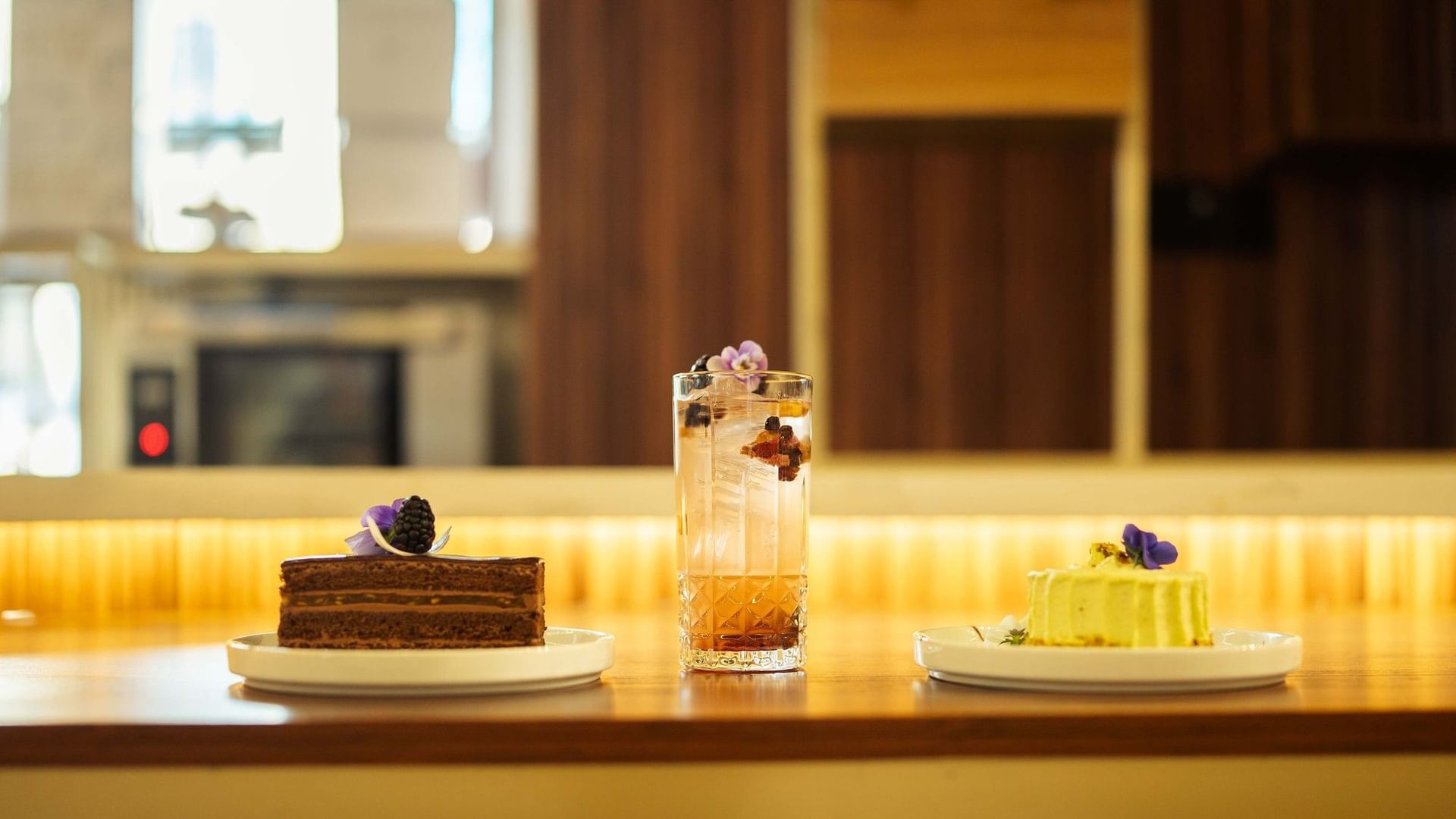 Chocolate cake slice and a lime dessert alongside a tall iced cocktail at Quinta Real in Puebla 