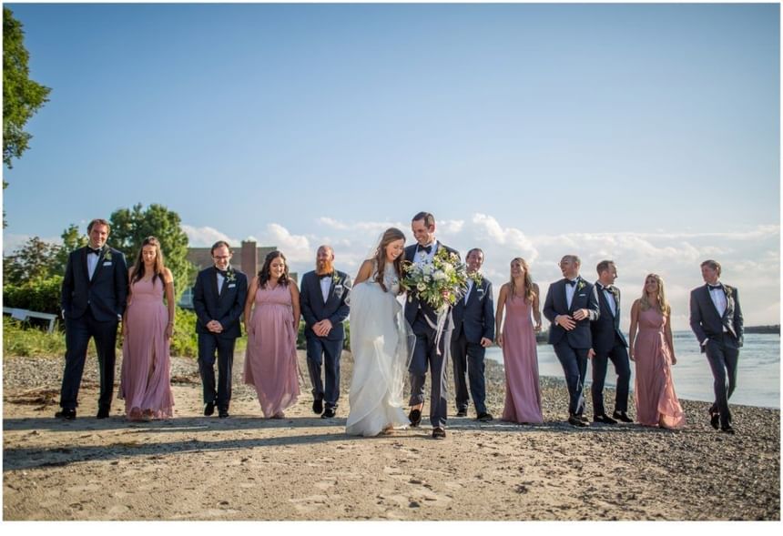 A bridal party on the beach at The Breakwater Inn & Spa