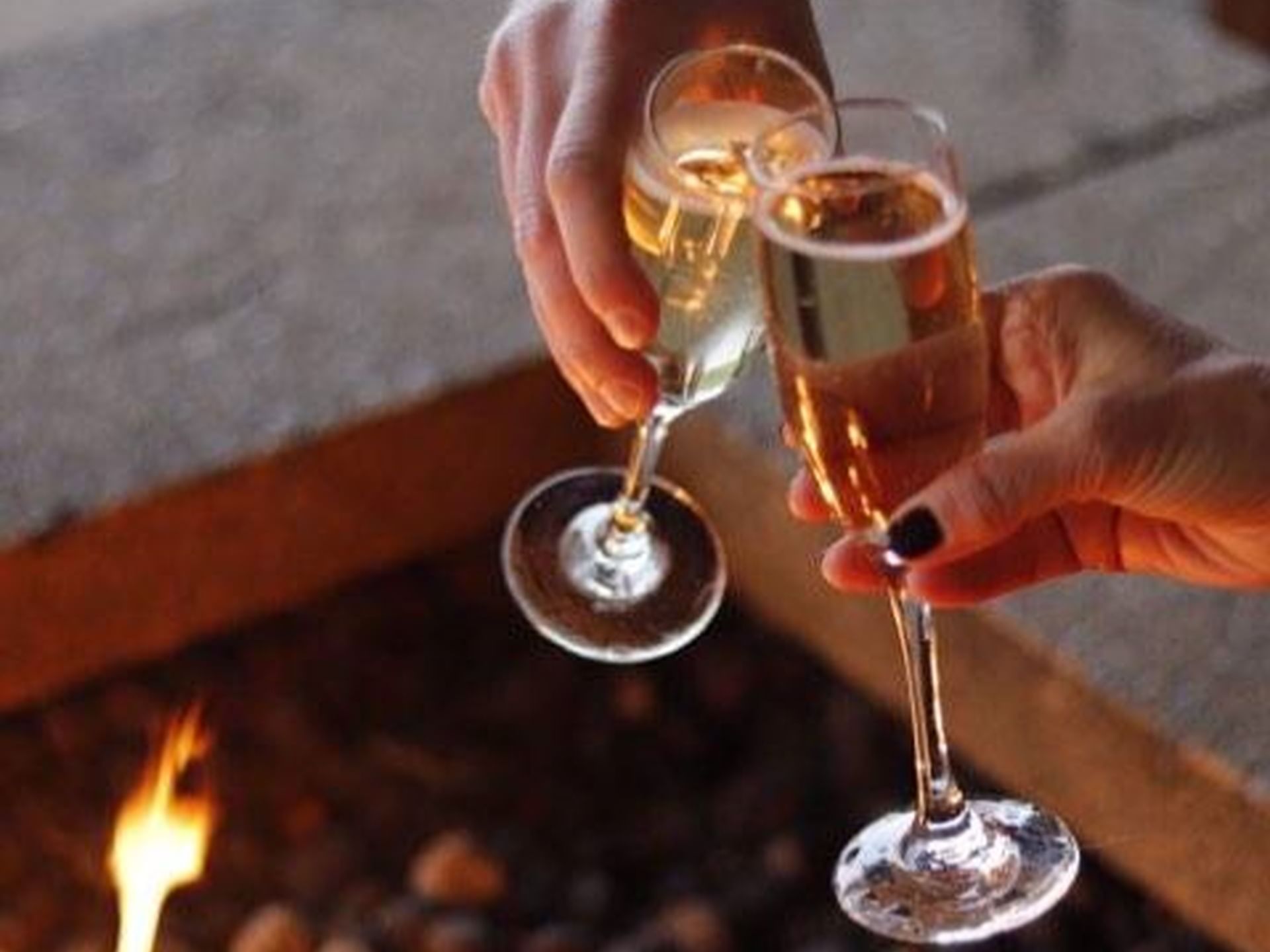 Close-up of a couple toasting champagne glasses at Alderbrook Resort & Spa