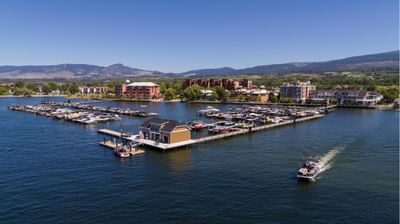 boat dock in ocean with mountains in background