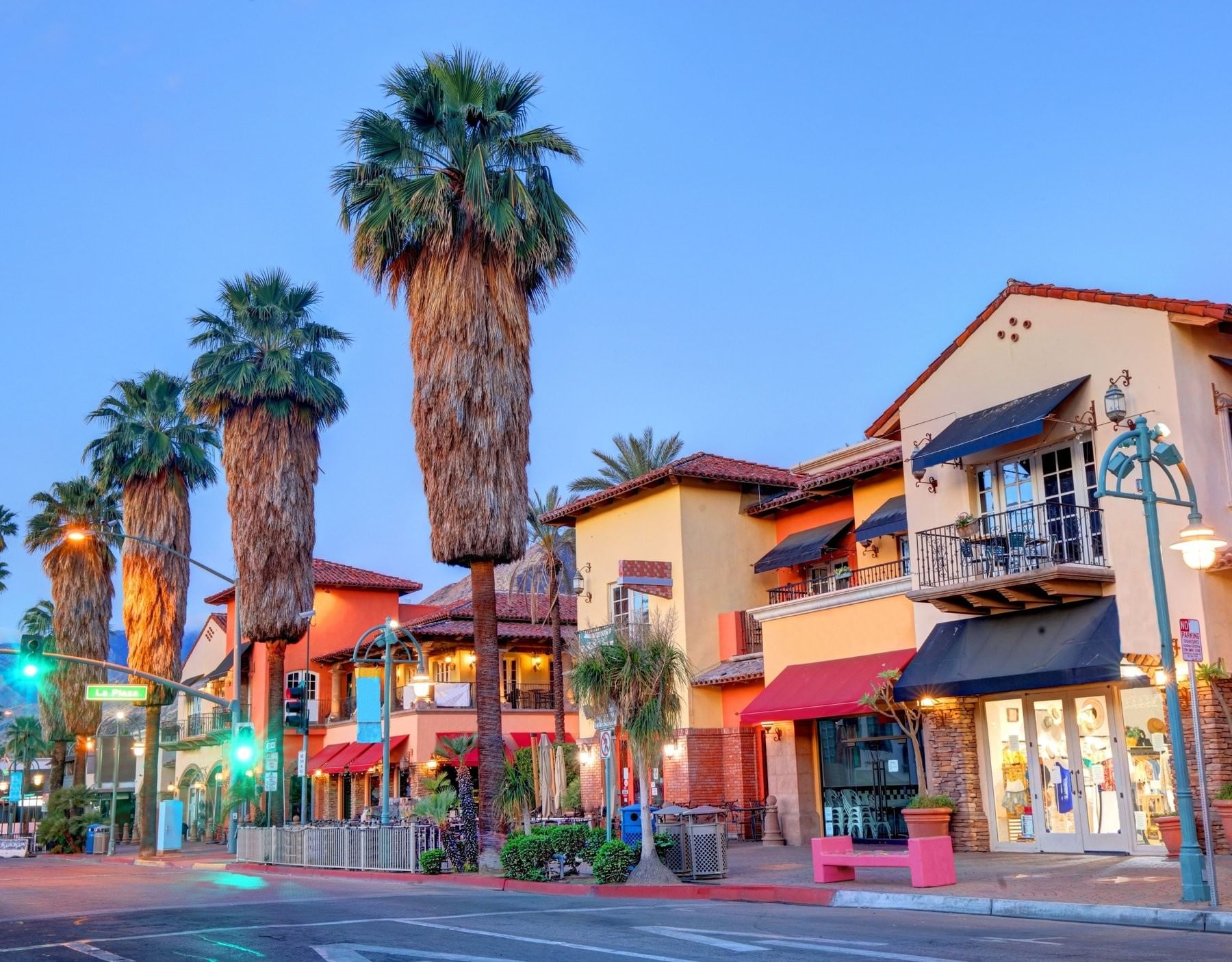 Downtown street near The Inn at Celebration with colorful buildings and tall palm trees