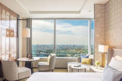 King bed with city view in Premium Deluxe bedroom at Eastin Grand Hotel Phayathai