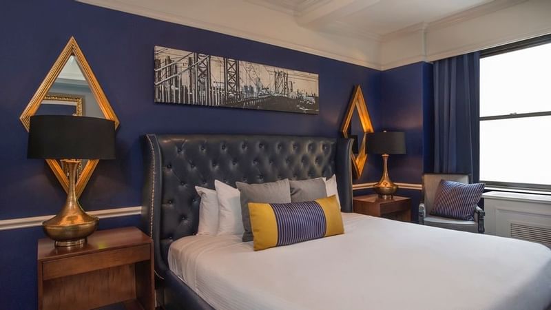 Comfy bed and side tables in Randolph Suite at Warwick New York