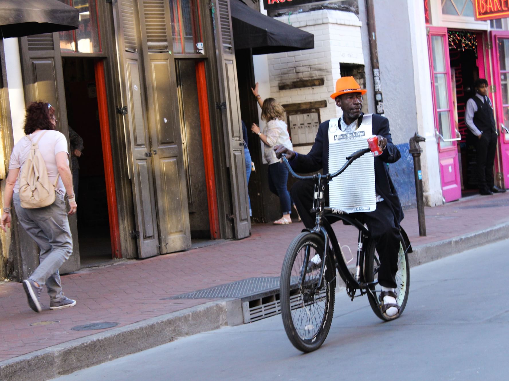 A man riding a bicycle in the streets near La Galerie Hotel