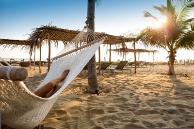 Lady relaxing on a hammock near Marea Beachfront Villas