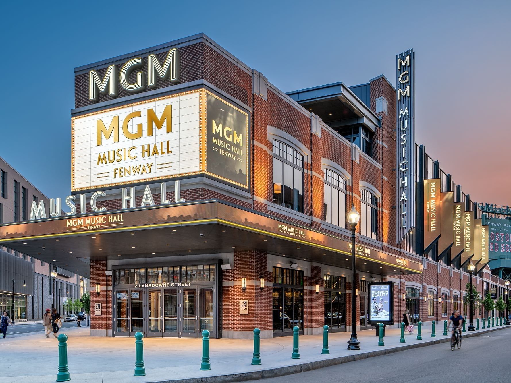 Exterior of the MGM Music Hall at Fenway at dusk with people milling about.