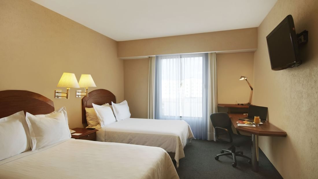 Twin beds with working desk In Superior Room at Fiesta Inn