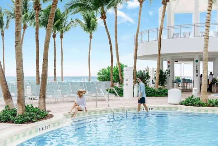 Couple Lounging by Pool - The Diplomat Beach Resort, South FL