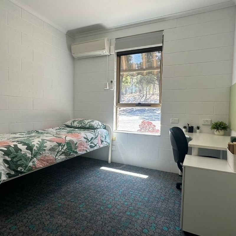Small room with a single bed and desk at La Trobe University - Orde House.