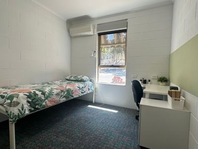 Small room with a single bed and desk at La Trobe University - Orde House.
