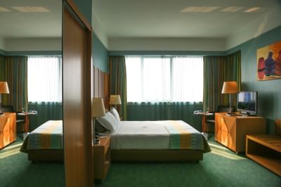 TV and work desk by the Double bed in Standard Room at Hotel Presidente Luanda