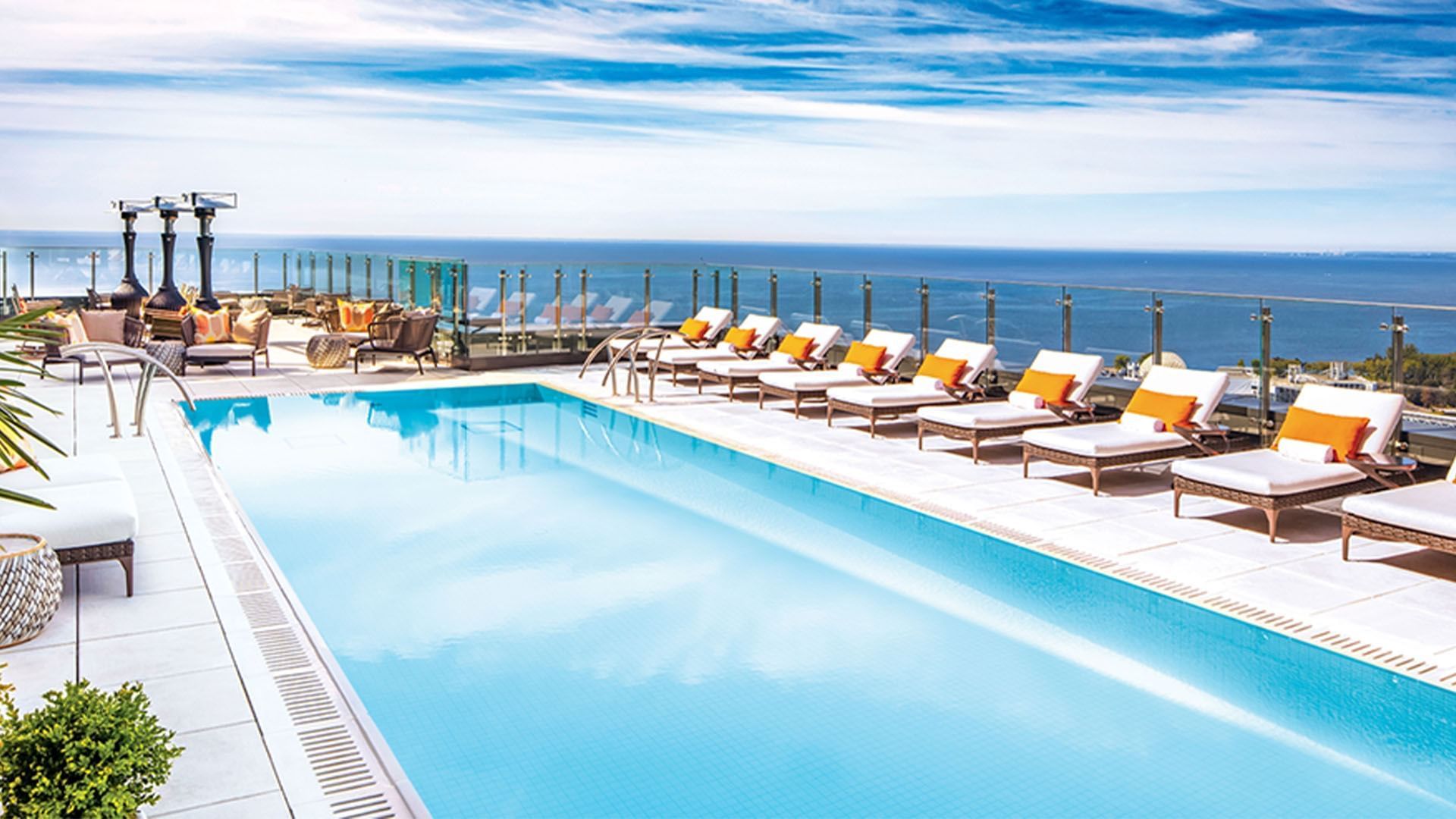 Rooftop Heated Pool with lounge chairs overlooking the ocean at Hotel X Toront