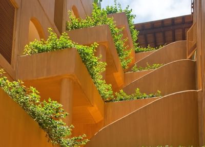 Low-angle view of balconies with plants at Cala de Mar