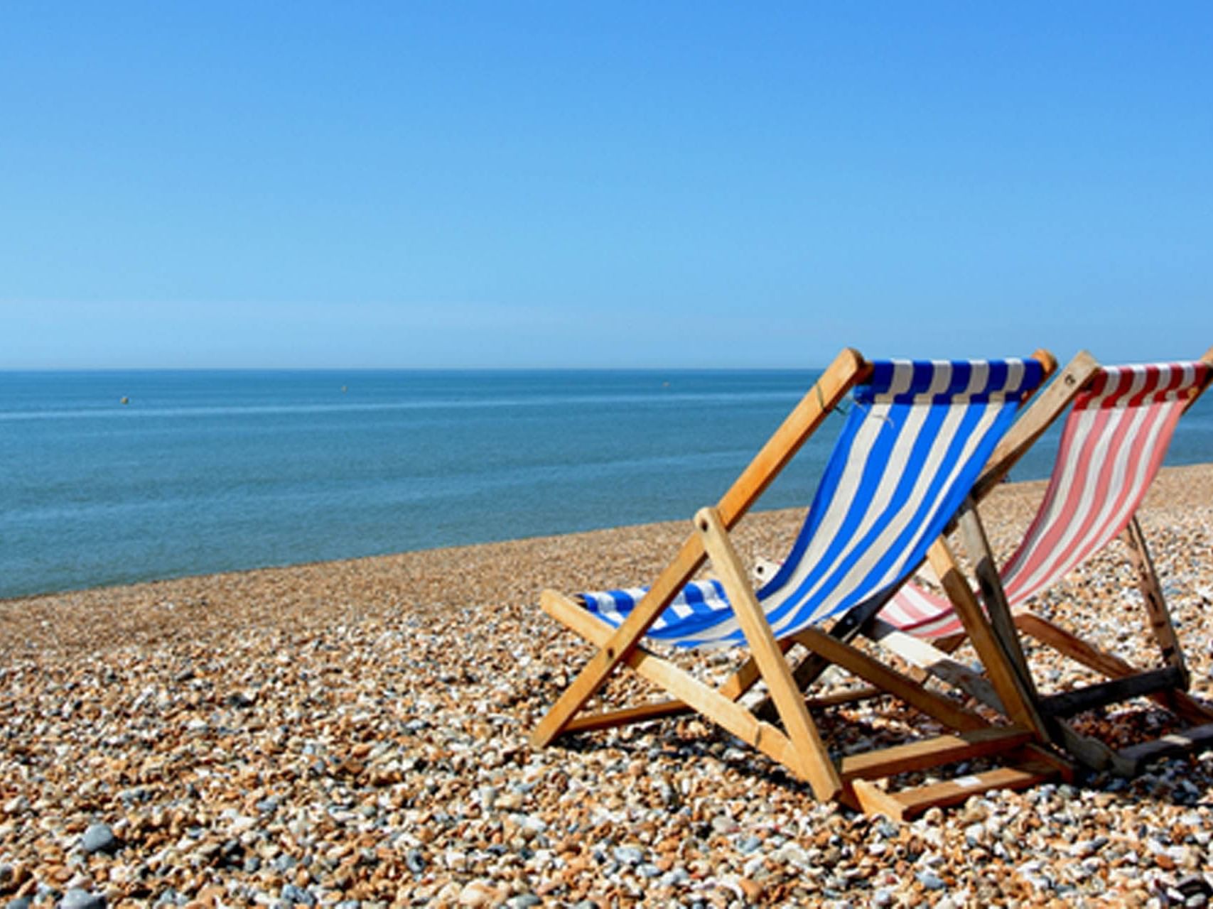 Two chairs on the beach by the sea near The View Eastbourne