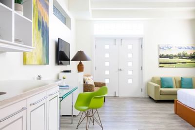 Work desk, TV & comfy sofa in Queen Premiere Spring Fling at Retro Suites Hotel