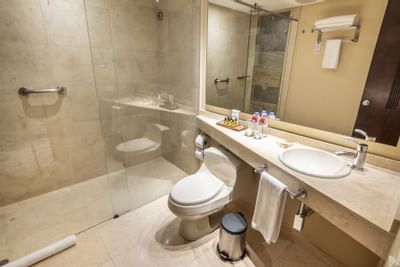 A bathroom in a room with necessary supplies
