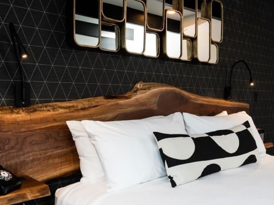 Close-up of the wooden textured headboard in King Water View Room at The Earl