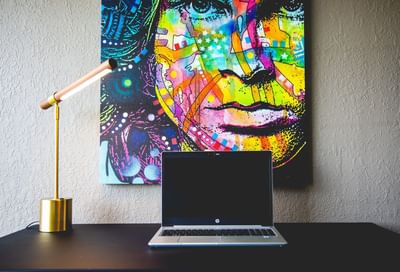 a laptop on a desk in a hotel room