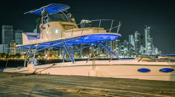 Night view of Dulzura 2 sport boat parked by the deck at Hotel Isla Del Encanto