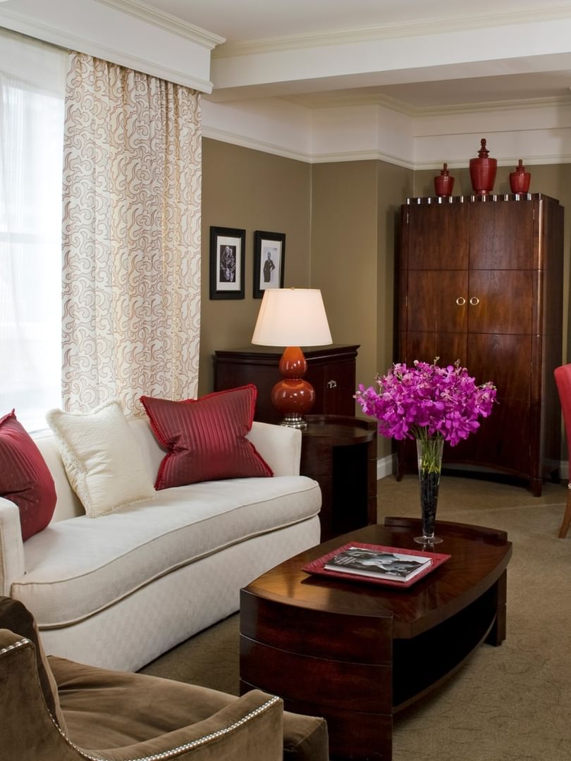 Hollywood Suite living area with a white sofa by a wood coffee table at Warwick New York