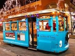 blue trolley with holiday lights