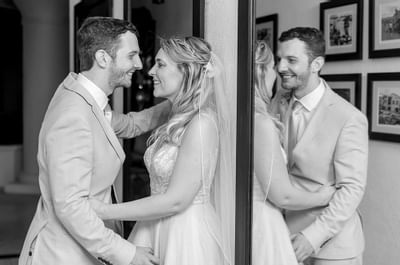 A married couple posing near a mirror at Bougainvillea Barbados